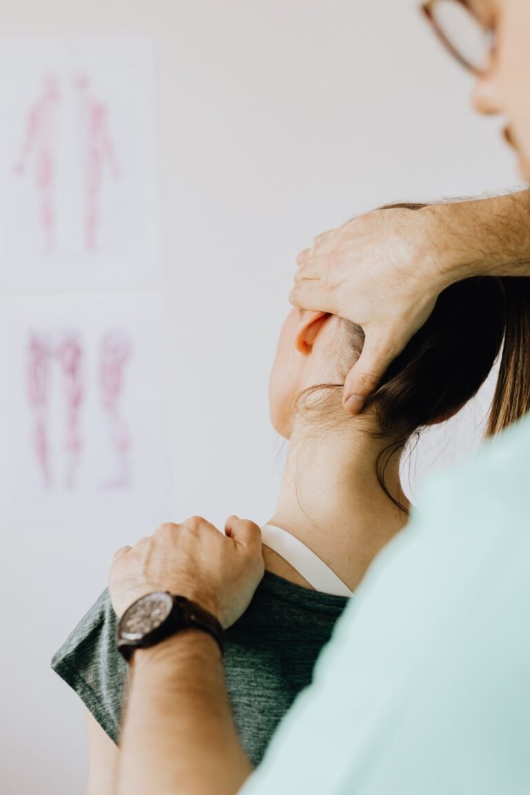 Massage therapist treating back and neck - Kati Basti Lower Back Therapy Jaipur