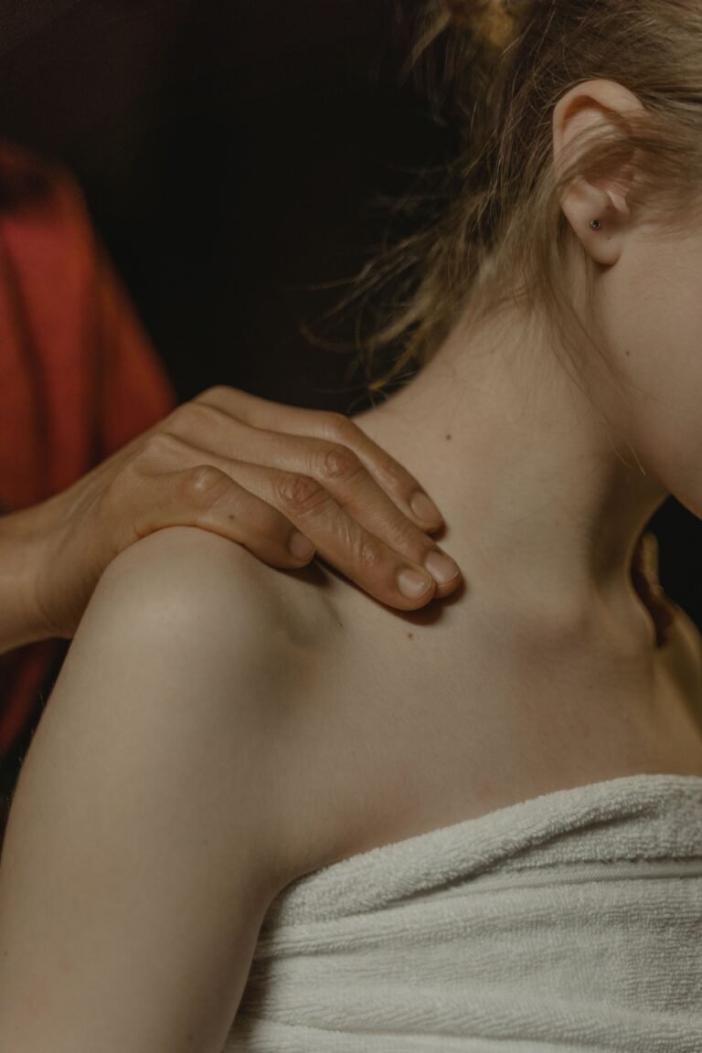 Therapist massaging shoulder for frozen shoulder Ayurvedic treatment in Jaipur