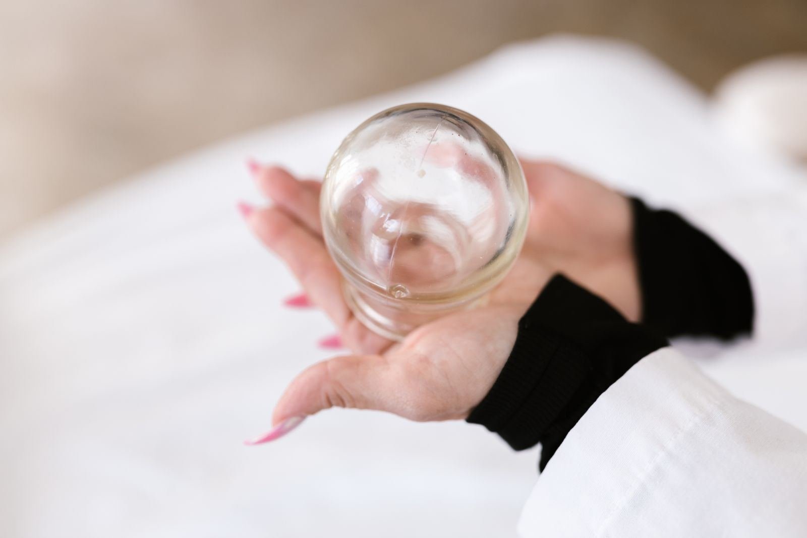 Person holding cupping glass - Jalauka Avacharana Leech Therapy Jaipur