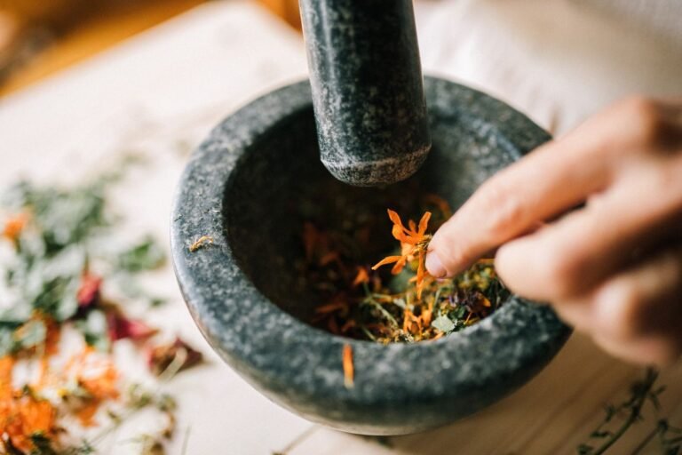 Hands crushing herbs for autumn seasonal wellness - Sharad Ritucharya Ayurvedic care in Jaipur