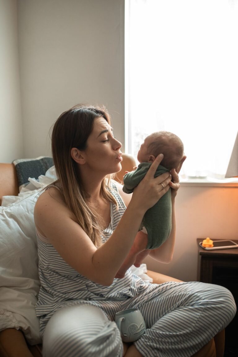 Mother gently holding newborn baby during postpartum recovery - Sutika Paricharya Ayurvedic treatment in Jaipur